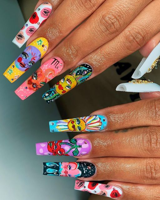 Close-up of a person's hands adorned with long, coffin-shaped fake nails, each painted with a distinct, colorful, artistic…