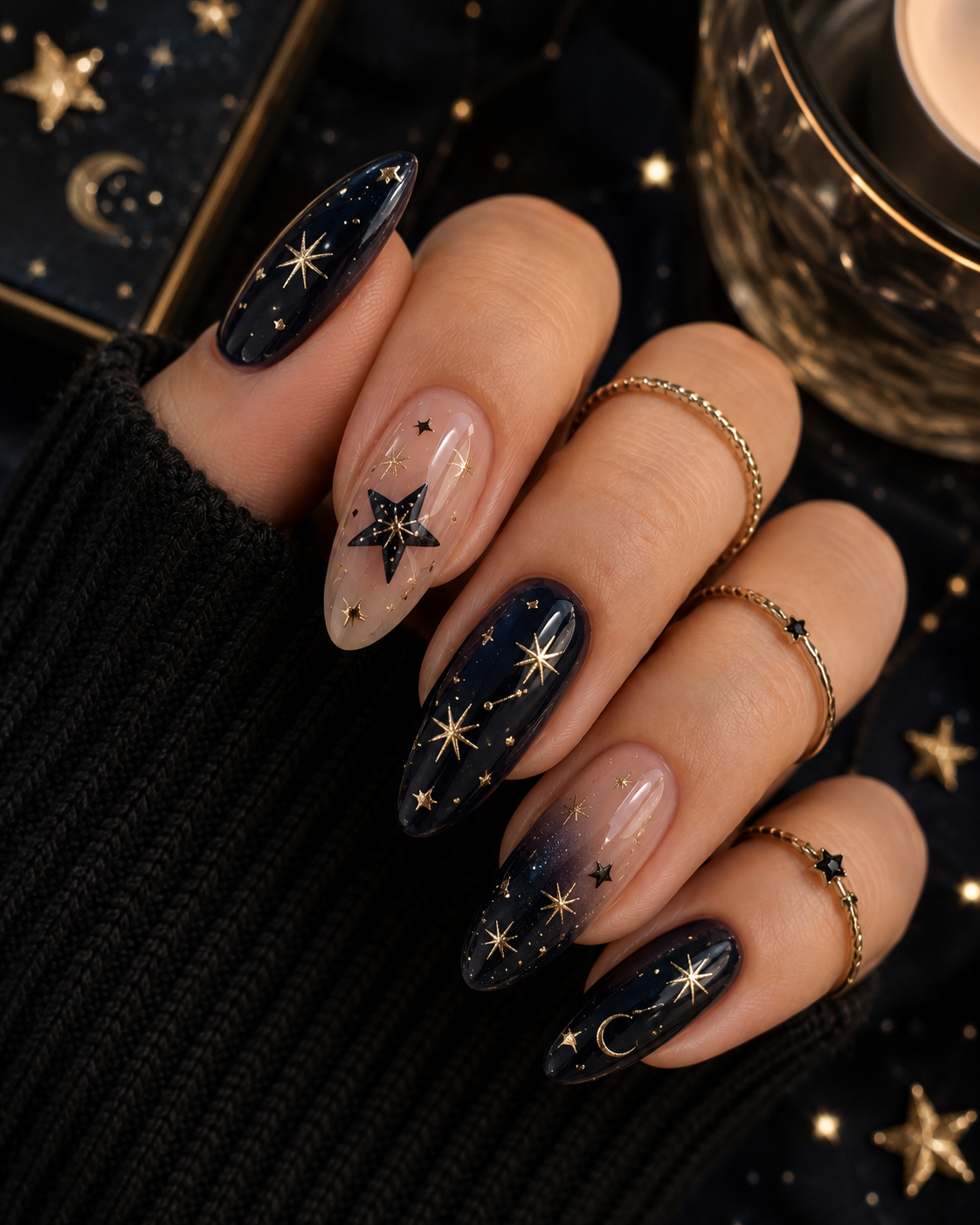 Close-up of manicured hand wearing dark celestial nail art.