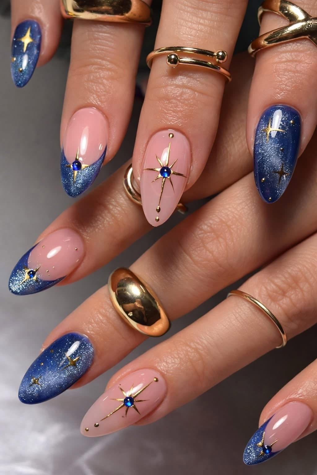 Close up of manicured hands with almond-shaped nails in a celestial theme.