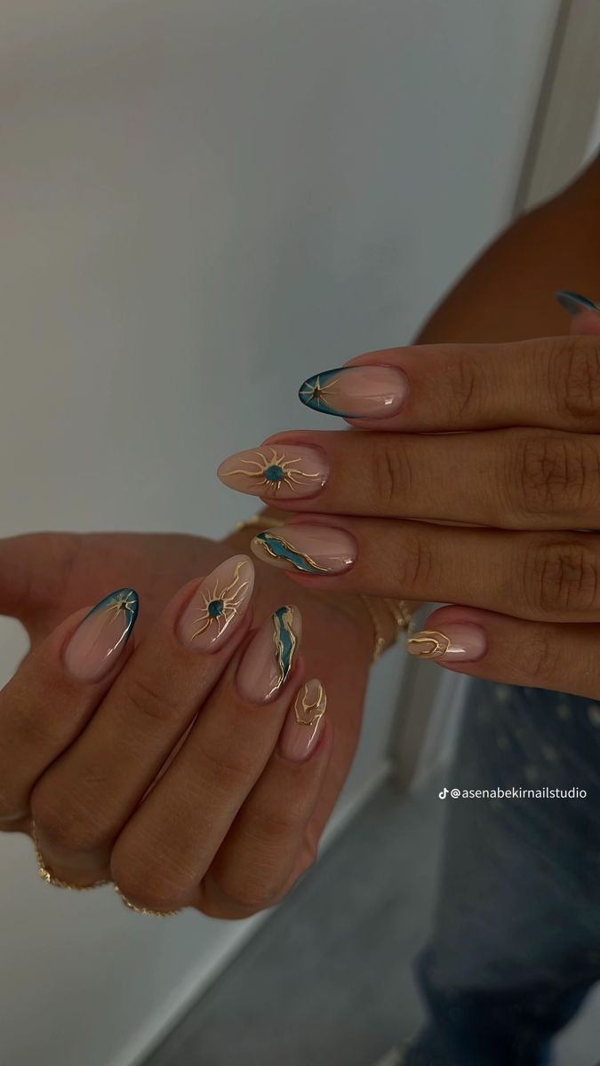 Close-up of manicured hands with almond-shaped nails. Designs include teal french tips with gold stars and full nude nails…