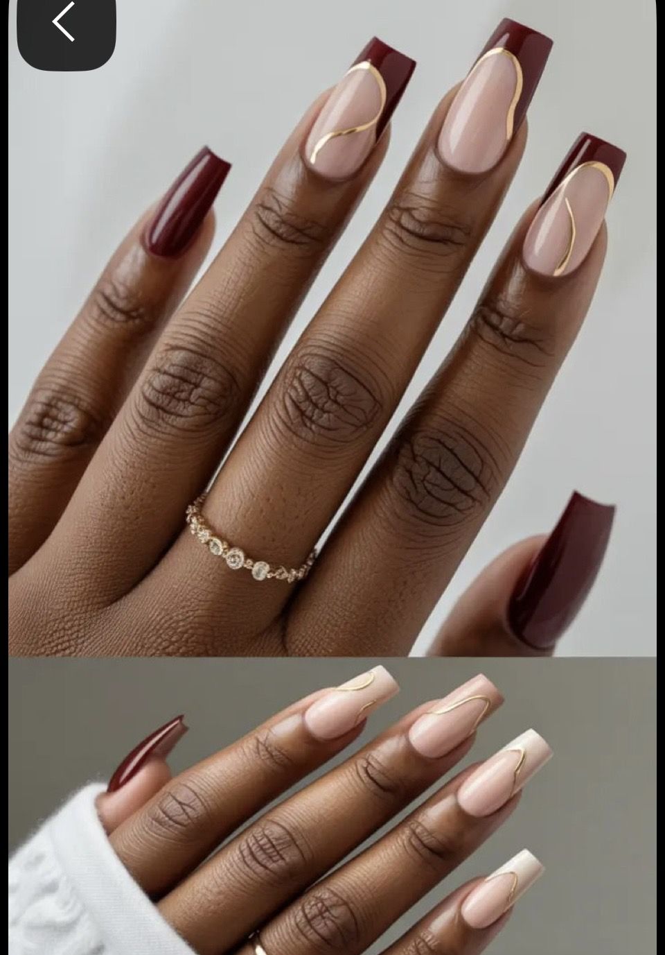 Close-up of a hand with burgundy and nude coffin-shaped nails, some with gold swirl accents.