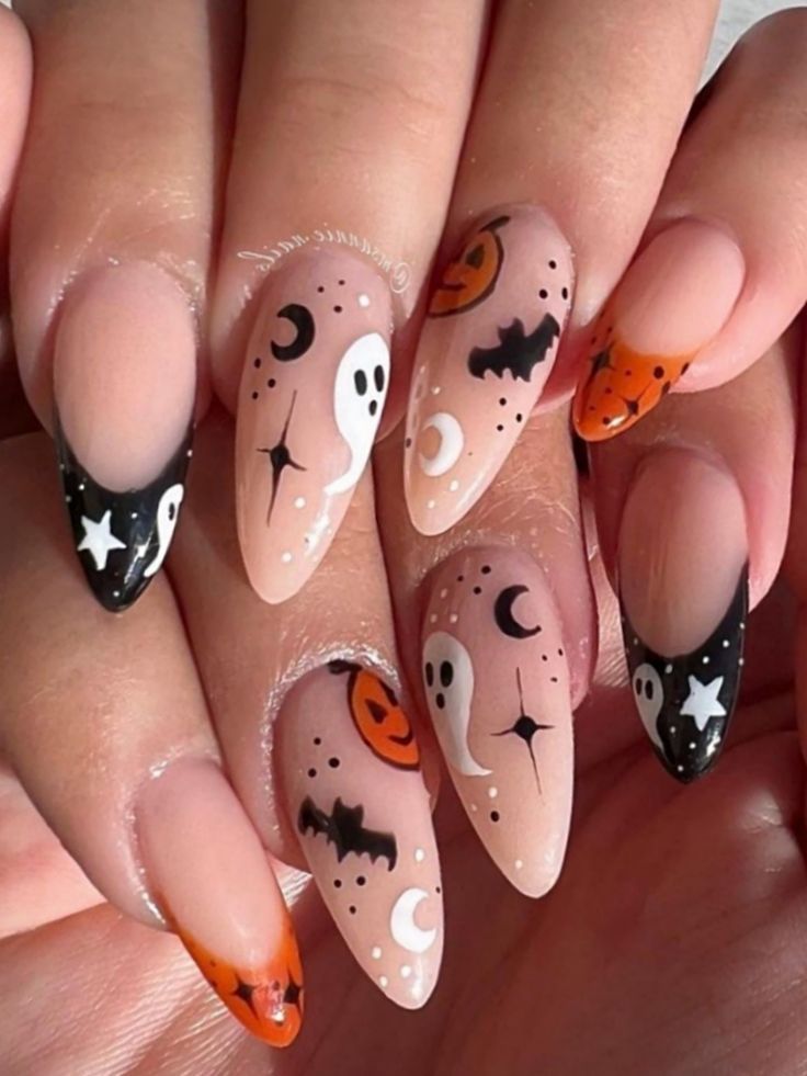 Almond-shaped nails with a clear base, featuring Halloween designs like ghosts, bats, pumpkins, moons, and stars.