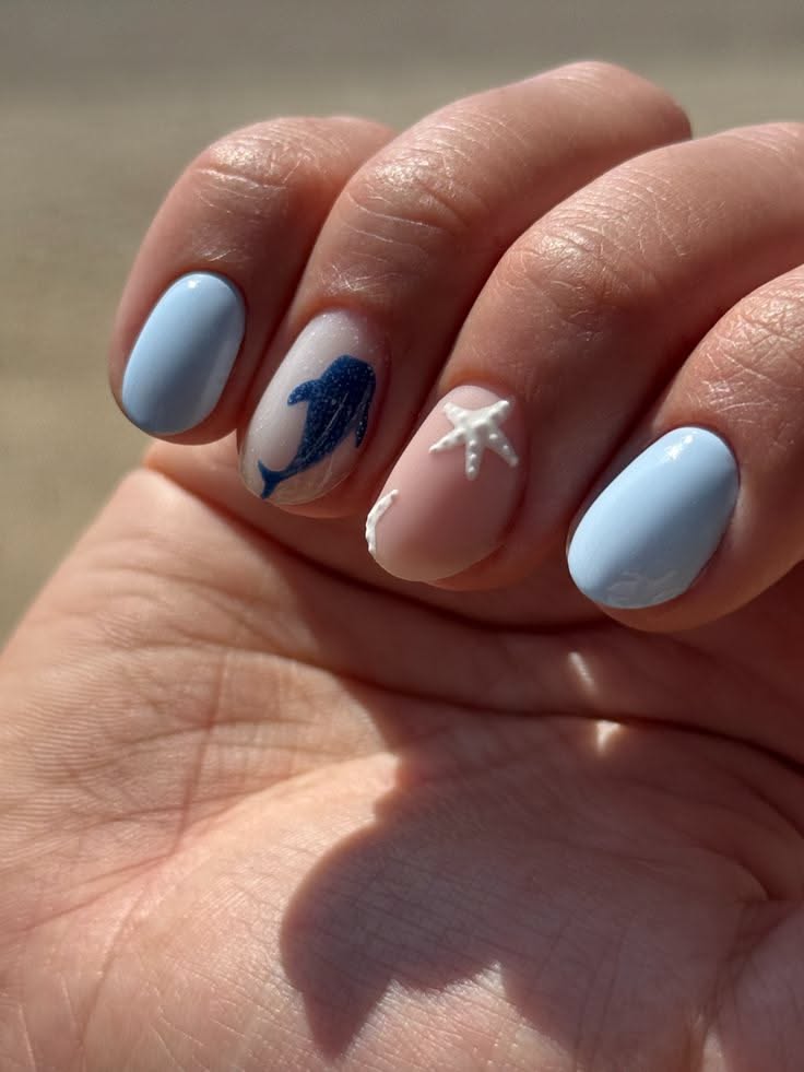 Close up of a hand with short, light blue, pink, and white nails.