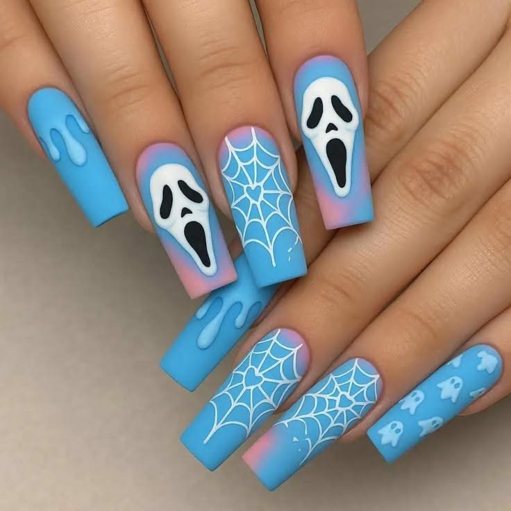 Close-up of blue and pink ombré long square nails featuring Ghostface masks, spiderwebs, dripping patterns, and small ghosts.
