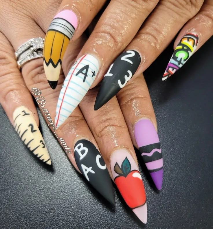 Long pointed nails with colorful back-to-school-inspired nail art.