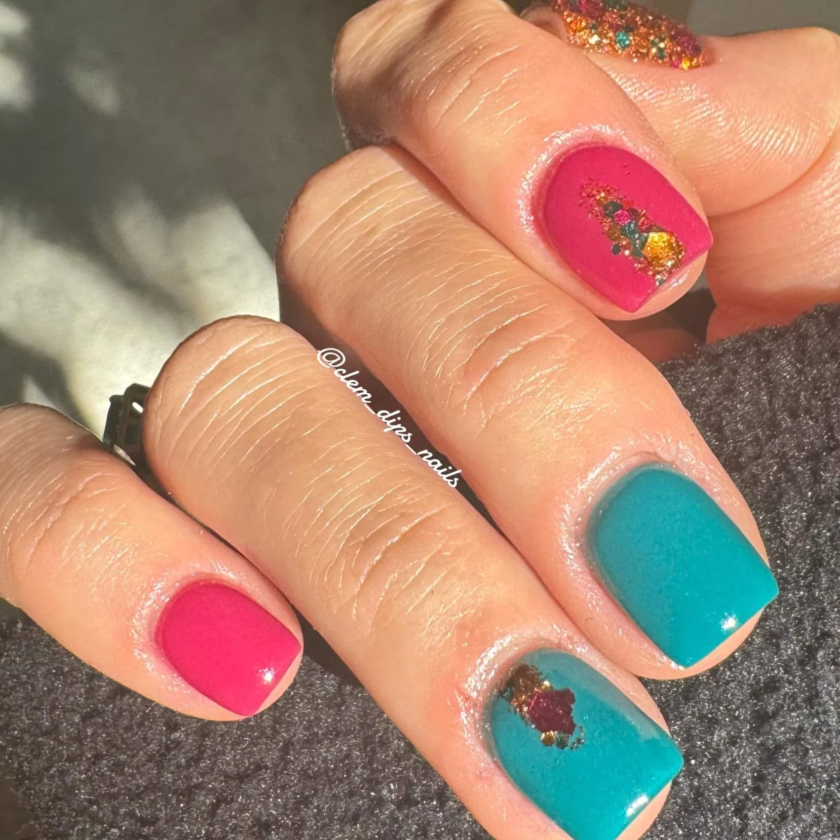 Hand with multicolored summer manicure in bright pastel shades